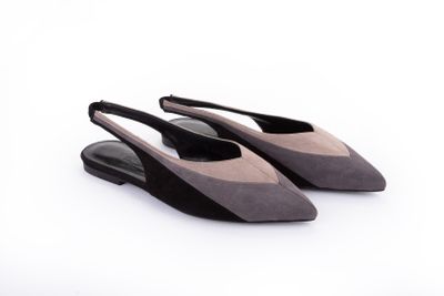les chaussures noires et grises sont posées sur une surface blanche