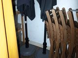 many chairs and umbrellas in a room next to each other
