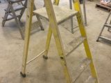a ladder that is sitting in the middle of a room