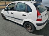 a picture of a small white car parked on the side of the road