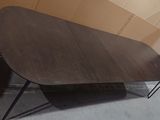 a wooden table with black legs and a brown table top