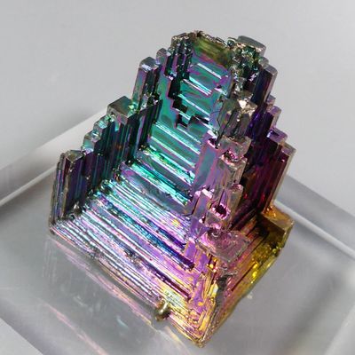 a very colorful piece of crystal on a clear plate