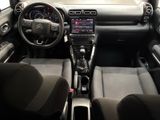 the interior of a small car with a steering wheel and dashboard