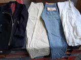 three pairs of jeans and a jacket sitting on a box