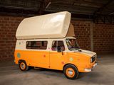 an orange and white van parked in a garage