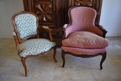 two chairs sitting next to each other in a room
