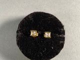 pair of diamond stud earrings in a velvet case
