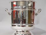 silver plated ice bucket with handles and handles on a stand