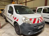 a white van with red and white stripes parked in a garage