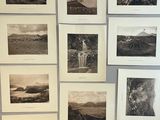several black and white photographs are hanging on a wall in a room