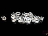 a close up of a bunch of diamonds on a black surface