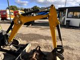 a yellow excavator that is sitting in the dirt
