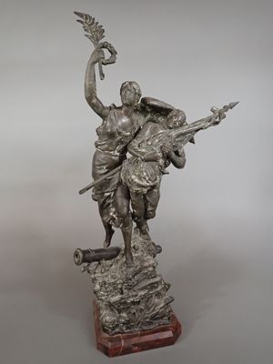 a silver statue of a woman holding a bird on top of a wooden base