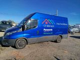 a blue van that is parked in the dirt
