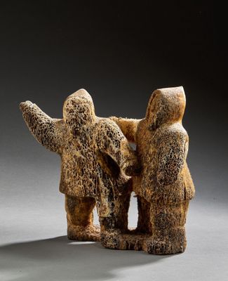 two figurines of people standing next to each other on a gray surface