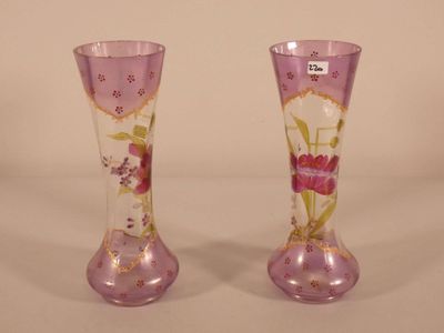 two vases with flowers painted on them on a table