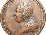a close up of a coin with a woman ' s head on it