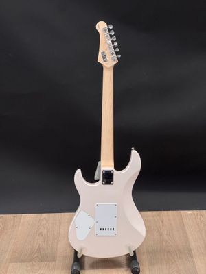 a white electric guitar sitting on top of a wooden table