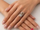 a woman ' s hands with a diamond ring on it