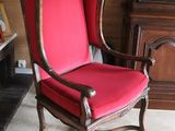 a red chair that is sitting in a living room