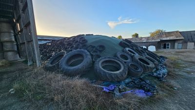a pile of tires sitting on top of a pile of trash