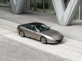 a silver sports car parked in front of a building