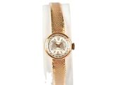an image of a woman ' s wrist watch with a gold band