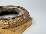 a gold plate with a ring on top of it
