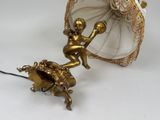 a statue of a little boy riding a horse with an umbrella
