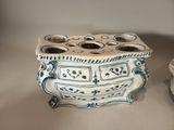 pair of blue and white vases on a table with a candle holder