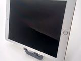 a tablet that is sitting on a stand on a table