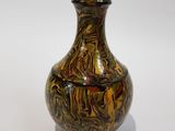 a vase that is sitting on a white surface