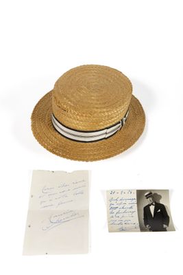 a straw hat with a striped band and a handwritten note