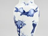 a blue and white vase with animals on it