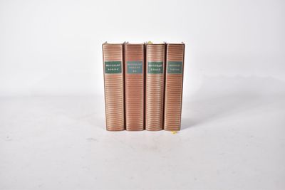 trois livres superposés sur une surface blanche