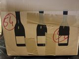 a cardboard box with three bottles of wine on it