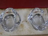 two glass ashtrays sitting on top of a box