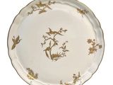 a plate with a bird and flowers design on it