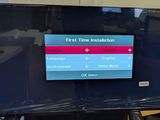 a flat screen tv sitting on a stand in a room
