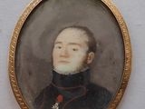 an old picture of a man in a military uniform in a gold frame