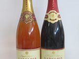 two bottles of wine sitting next to each other on a table