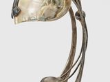 an image of a sculpture of a bird with a shell on it ' s head