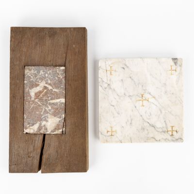 two pieces of marble on a wooden frame and a piece of wood on a white surface