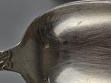 two spoons that are sitting next to each other