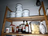 a wooden shelf filled with various containers and ingredients