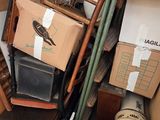 a pile of boxes and a chair in the corner of a room