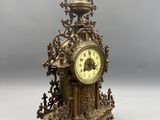 a gold clock that is sitting on a table