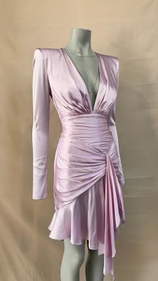 the mannequin is wearing a pink dress with long sleeves
