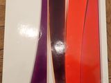 the book is on a wooden table with a red and purple striped design