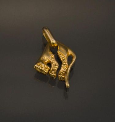 a gold charm that is on a black surface